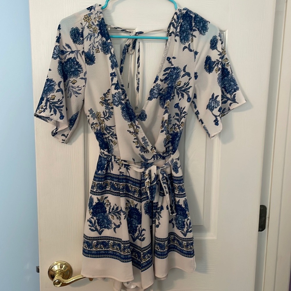 Women’s romper. Blue, white and yellow floral pattern.